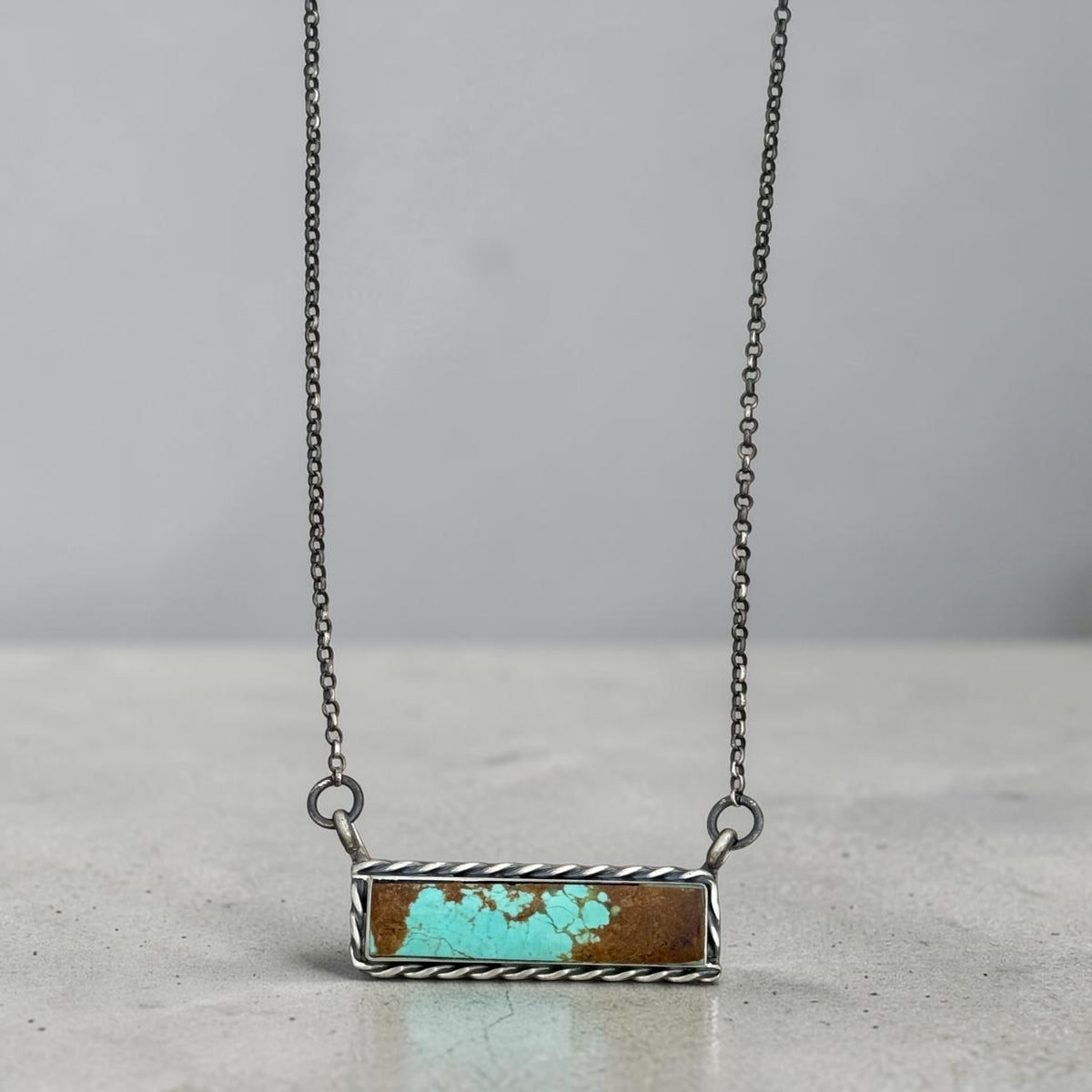 Hereford Valley rectangular turquoise bar necklace with a twisted rope sterling silver frame on a darkened chain